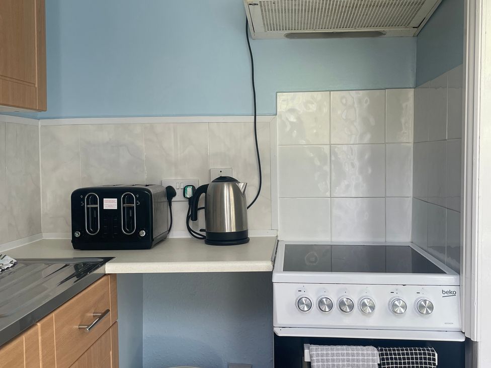 A kitchen with a toaster and kettle on the countertop at Apartment 6 in Torquay