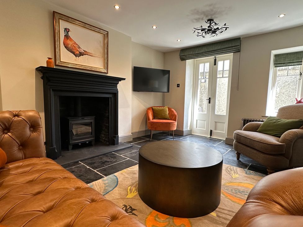 A living room with a sofa and fireplace at La'al Kirkstone Brow in Ambleside