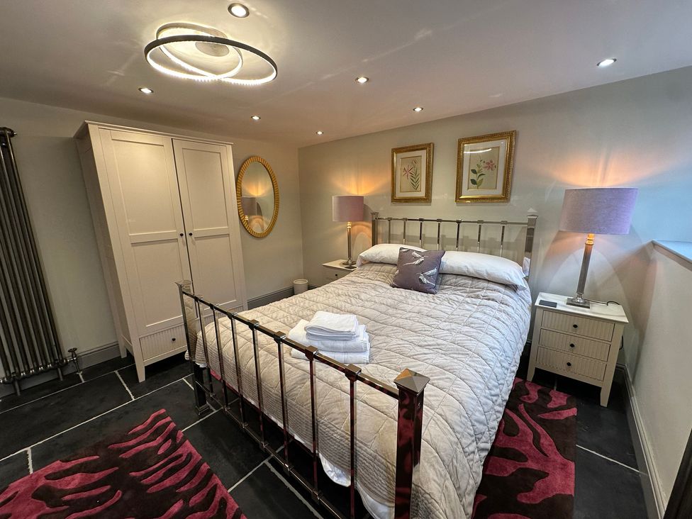 A bedroom with a bed and wardrobe at La'al Kirkstone Brow in Ambleside