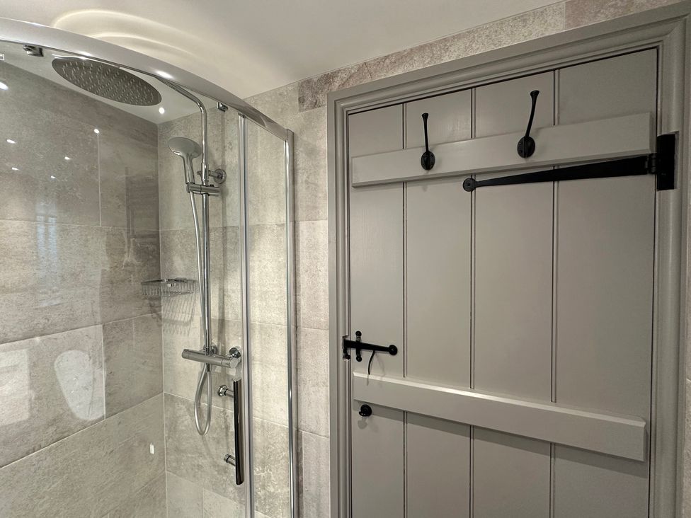 A bathroom with a shower and a sliding door at La'al Kirkstone Brow in Ambleside