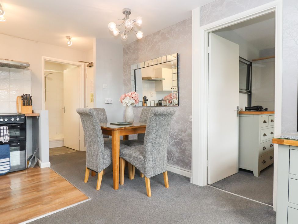 A dining room with a table and chairs in Apartment 10 Torquay