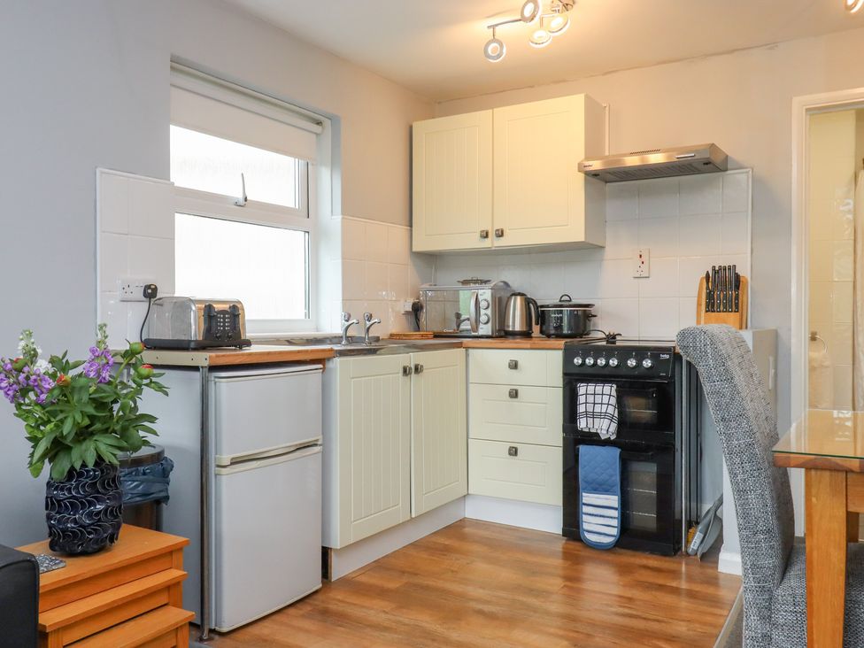 A kitchen with appliances and counter space at Apartment 10 in Torquay