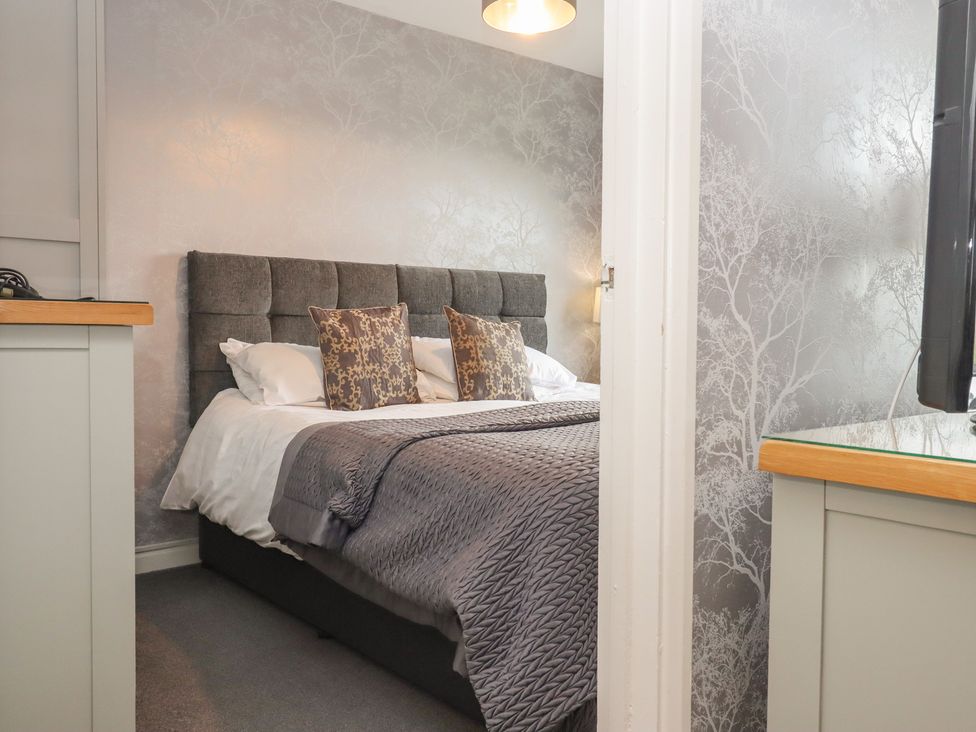 A bedroom with a bed and bedside table at Apartment 10 in Torquay