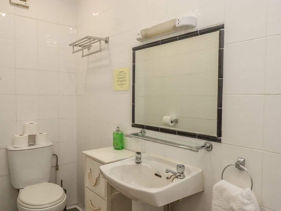 A bathroom with a sink and toilet at Apartment 10 in Torquay