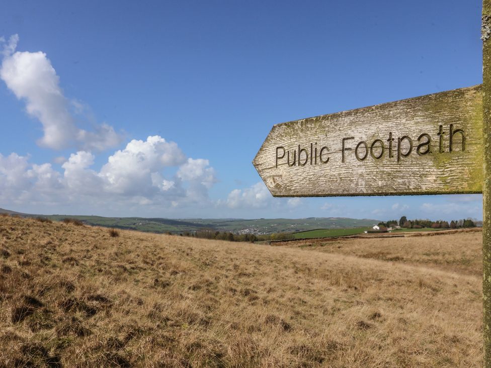 A sign indicating public footpath in a field near Ilkley