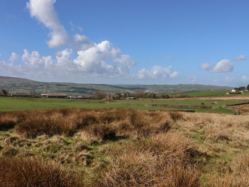 A landscape view with fields and hills at 1 Upper Austby Farm Cottage Ilkley