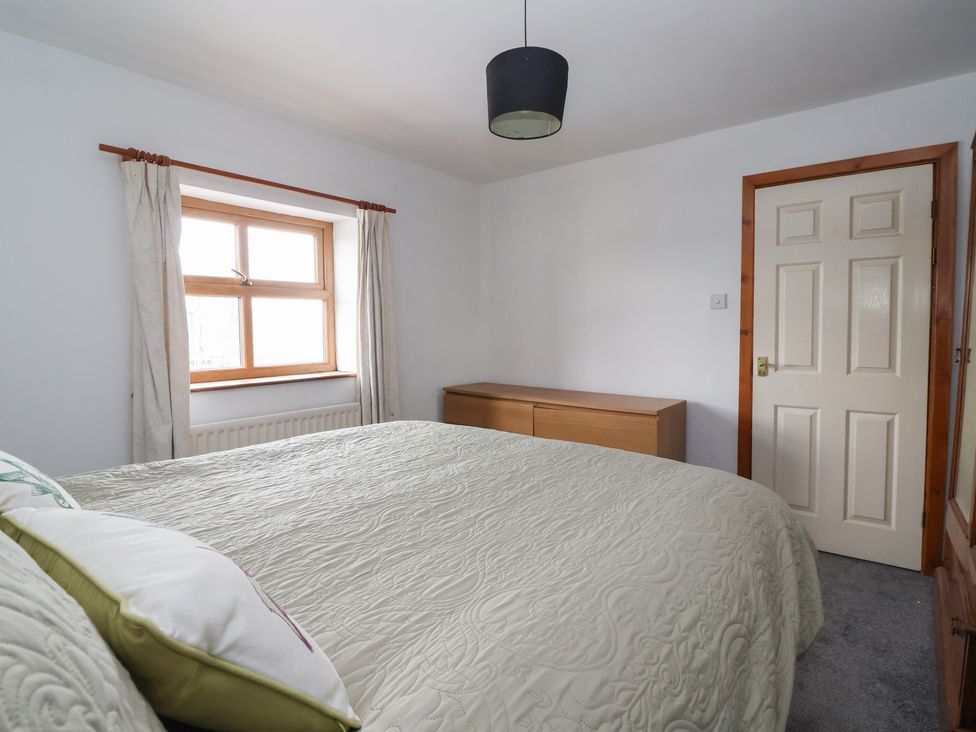 A bedroom with a bed, window, and chest of drawers at 1 Upper Austby Farm Cottage, Langbar near Ilkley