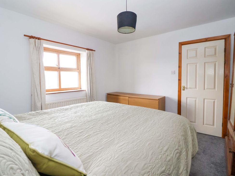A bedroom with a bed and chest of drawers at 1 Upper Austby Farm Cottage Langbar near Ilkley