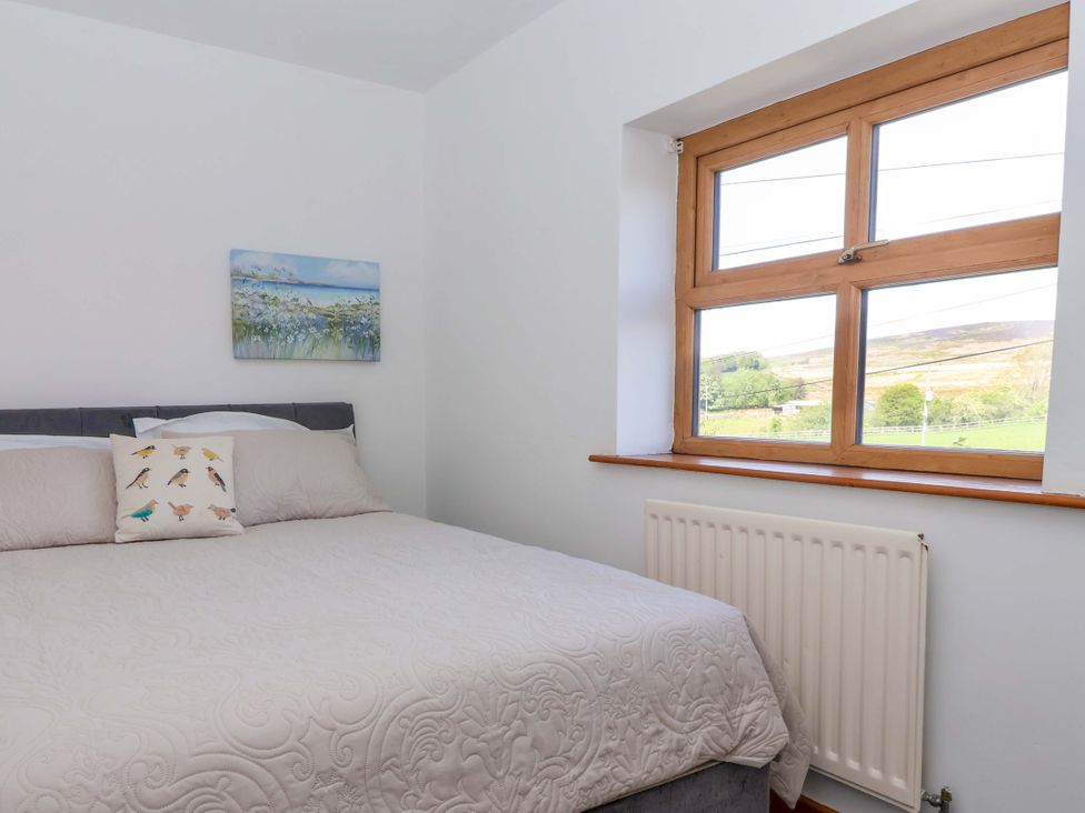 A bedroom with a bed and window at 1 Upper Austby Farm Cottage in Langbar near Ilkley