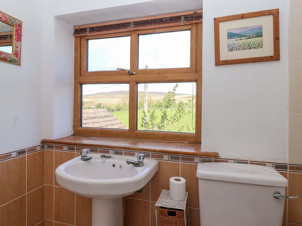 A bathroom with a sink and toilet at 1 Upper Austby Farm Cottage Langbar near Ilkley