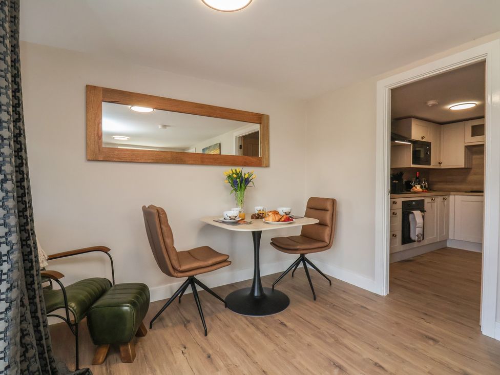 A dining area with a table and chairs at Little Holm Garth