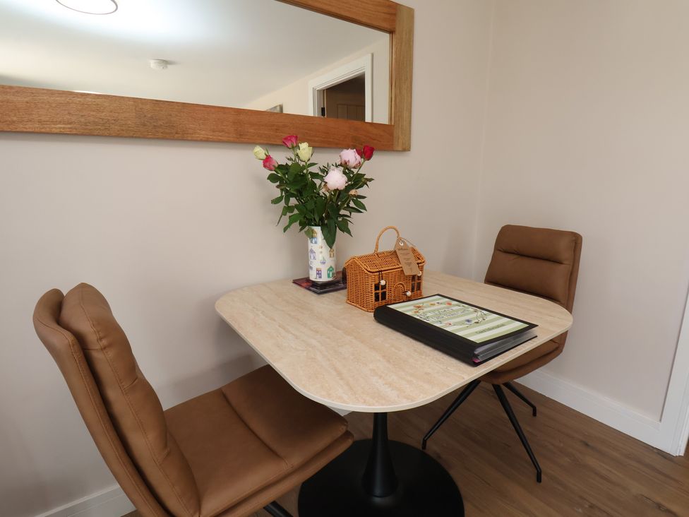 A dining room with a table and chairs at Little Holm Garth in Whitby