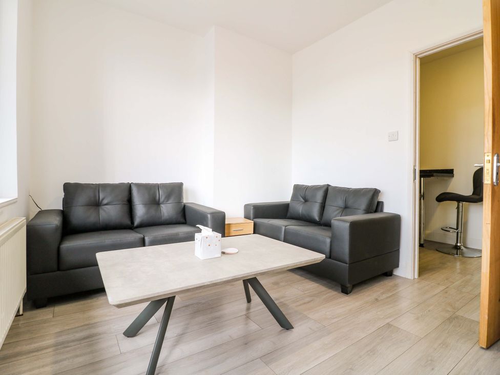 A living room with two sofas and a table at 57 Abbey Street