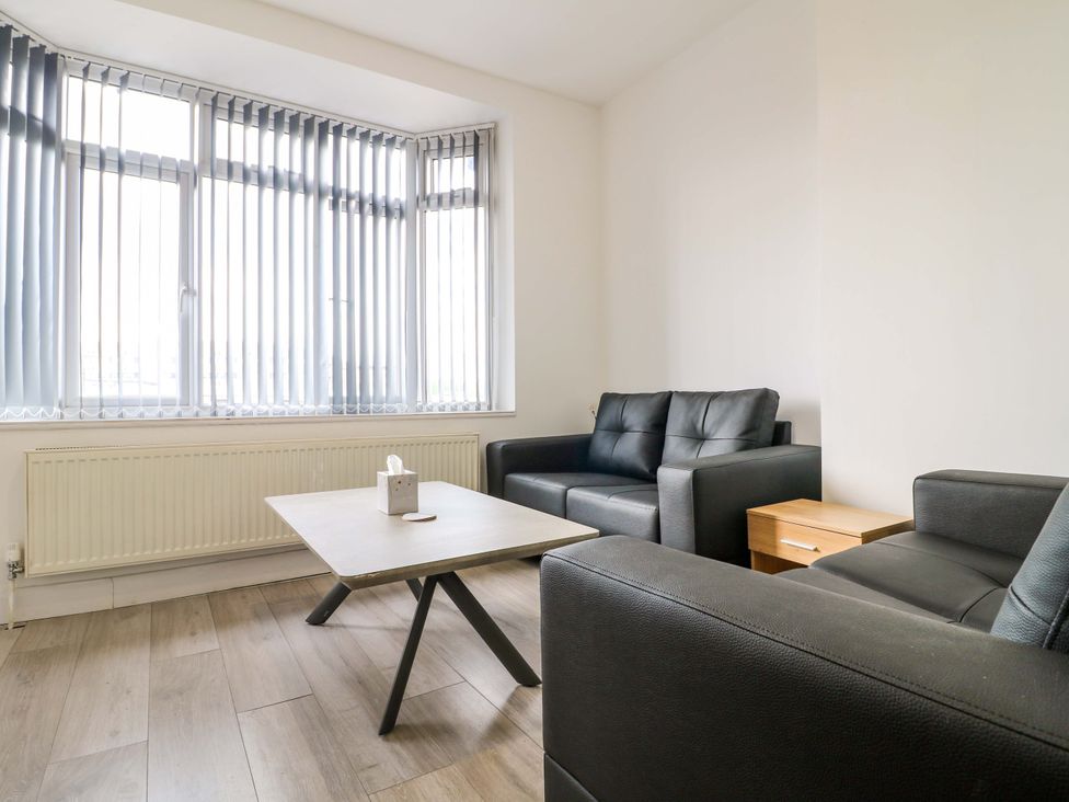 A living room with two sofas and a table at 57 Abbey Street