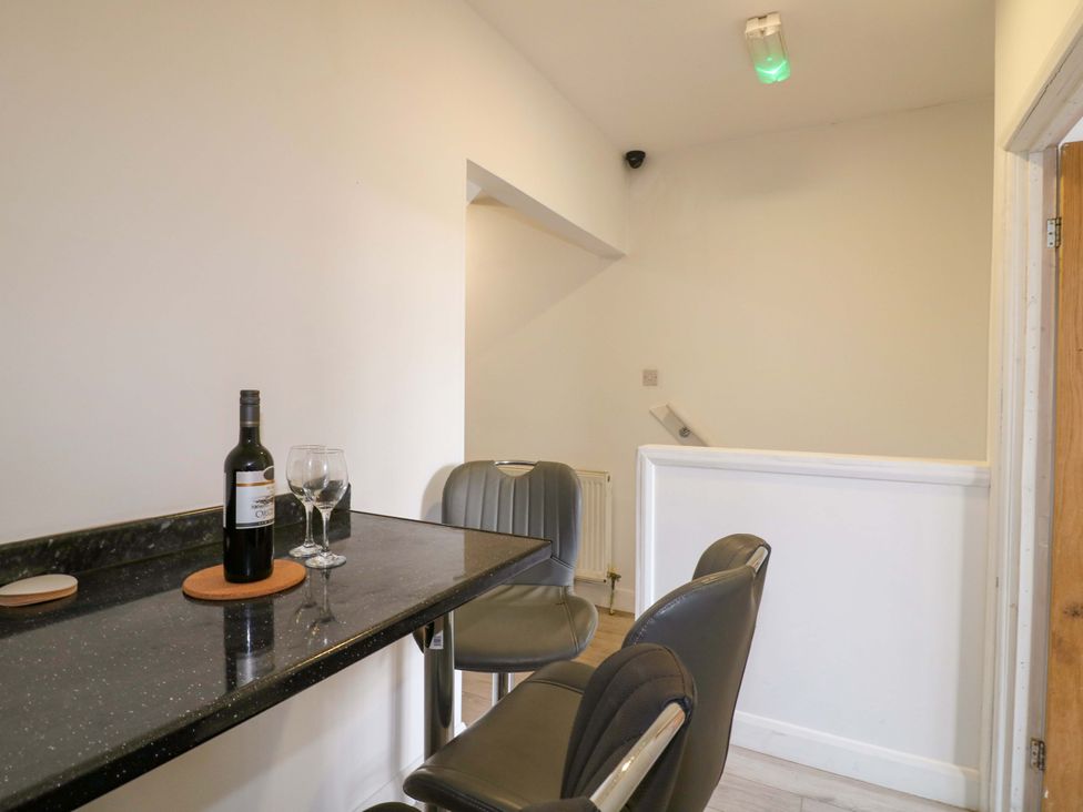 A bar area with a wine bottle and glasses at 57 Abbey Street