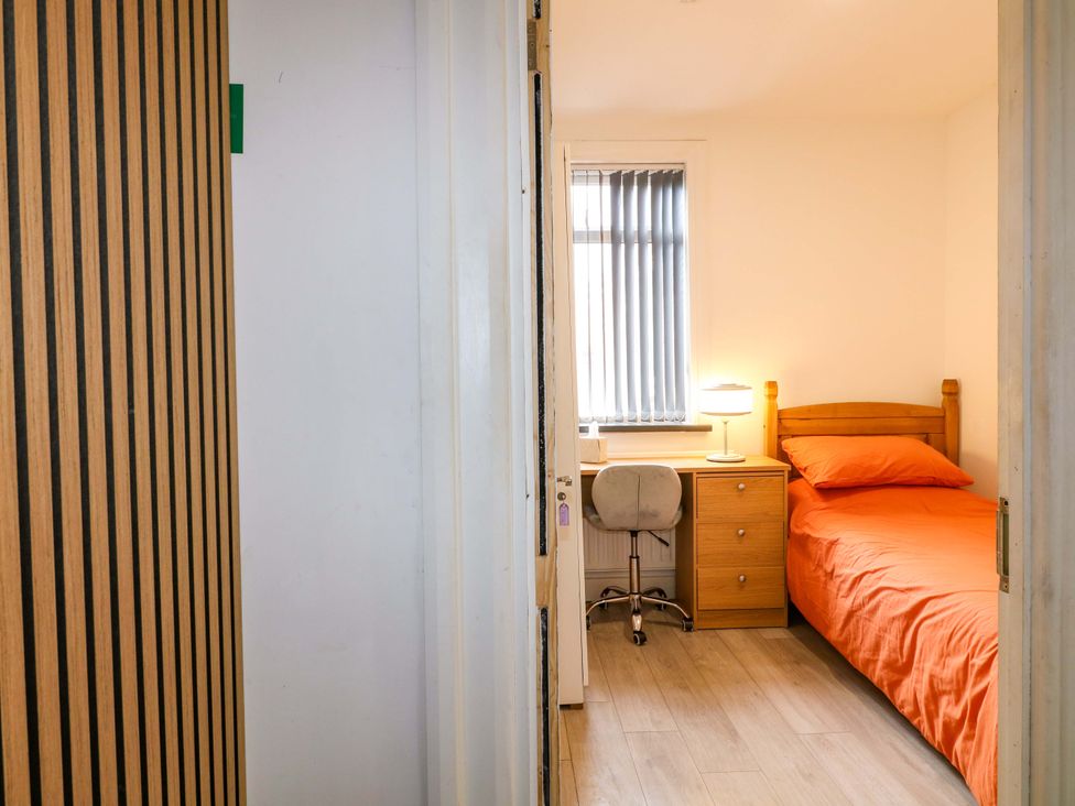 A bedroom with a bed and desk at 57 Abbey Street