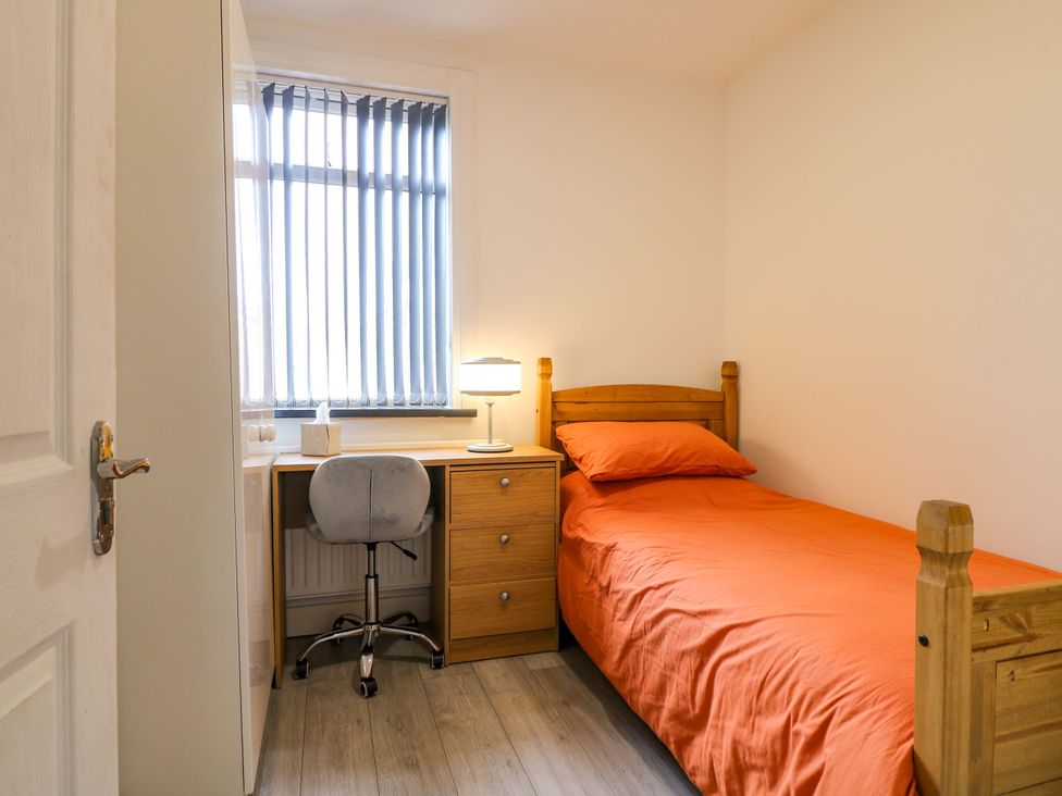 A bedroom with a single bed and a desk at 57 Abbey Street
