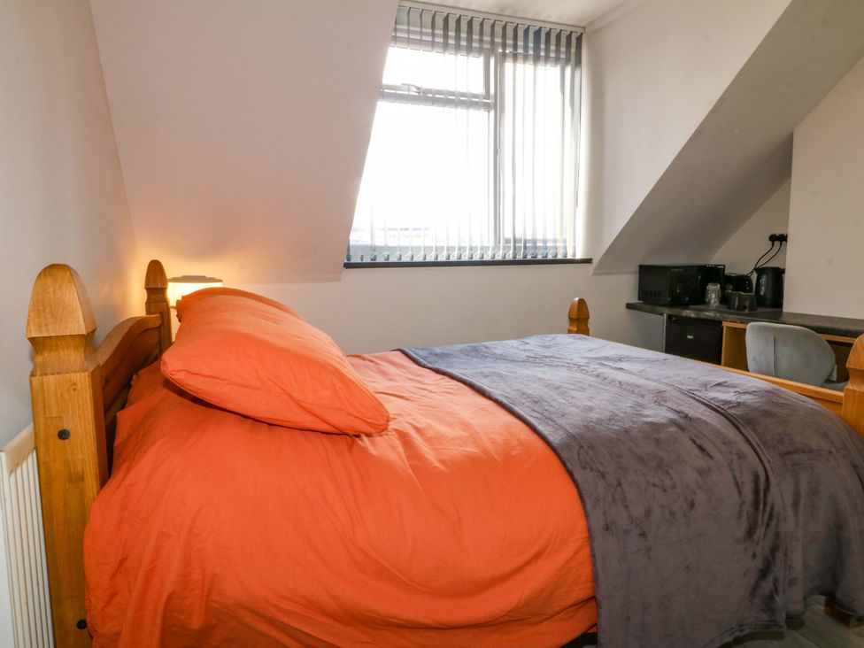 A bedroom with a bed and desk at 57 Abbey Street