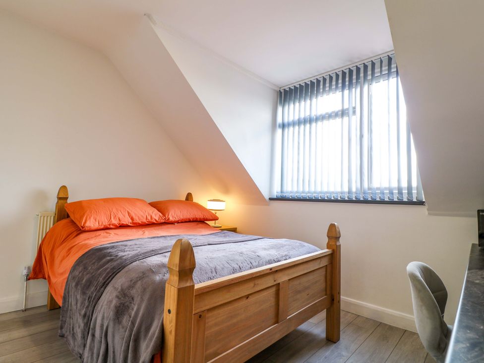 A bedroom with a bed and desk at 57 Abbey Street