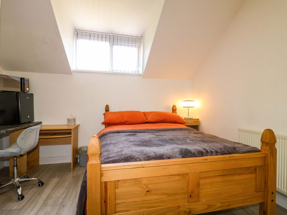A bedroom with a bed and desk at 57 Abbey Street