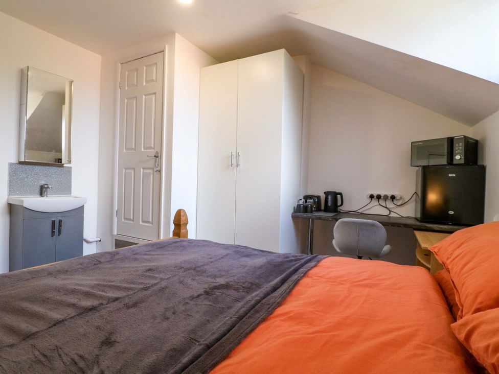 A bedroom with a bed and wardrobe at 57 Abbey Street