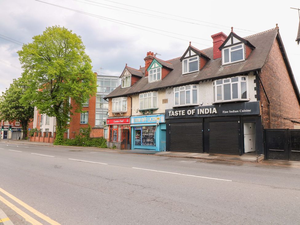 A street view with buildings and a tree at 57 Abbey Street