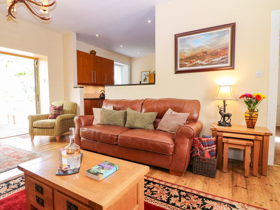 A living room with a sofa and coffee table at St Kilda in Ballater