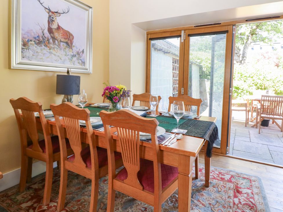 A dining room with a table set for dinner at St Kilda in Ballater