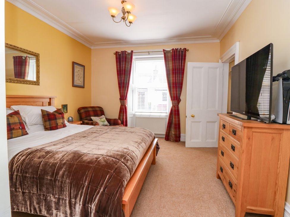 A bedroom with a bed and television at St Kilda in Ballater