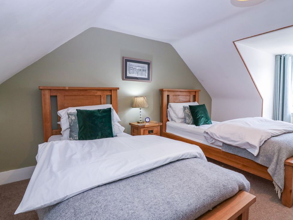 A bedroom with twin beds and a nightstand at St Kilda in Ballater