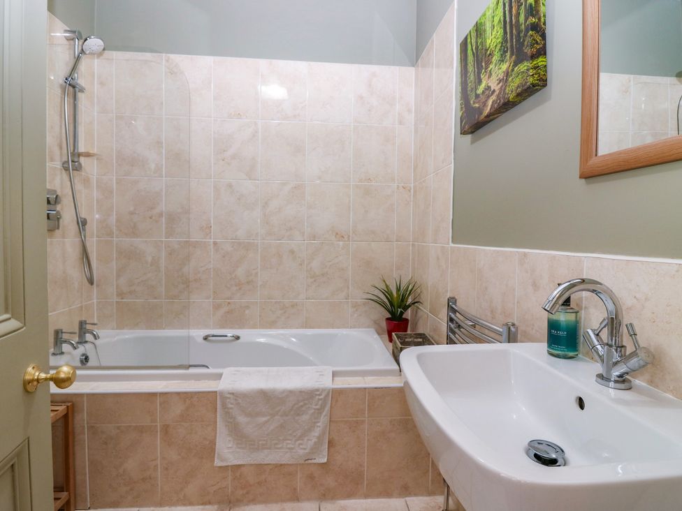 A bathroom featuring a shower, bathtub, and sink at St Kilda in Ballater