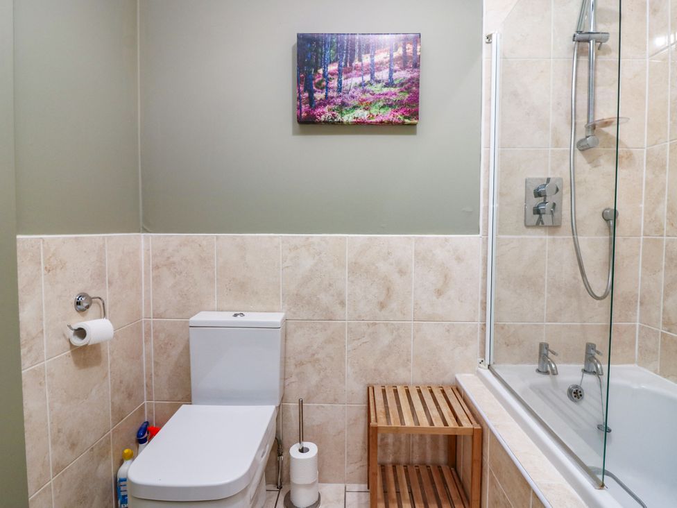 A bathroom featuring a toilet, shower, and bathtub at St Kilda in Ballater
