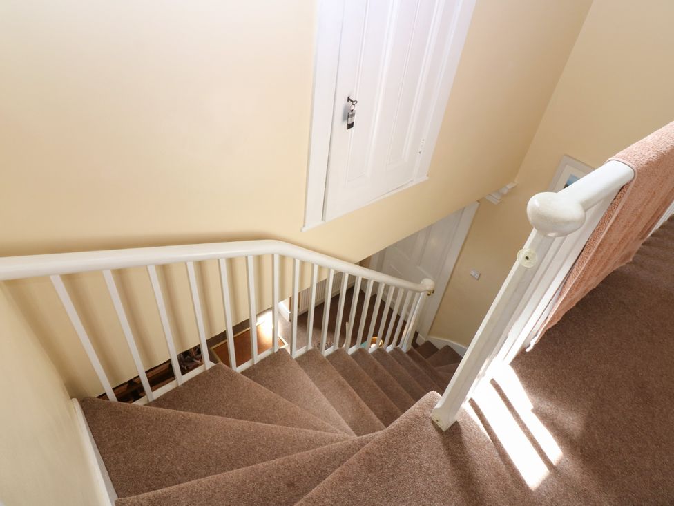 A staircase with carpet and a handrail at St Kilda in Ballater