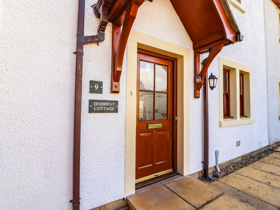 An entrance with a wooden door at Derwent Cottage in Cockermouth