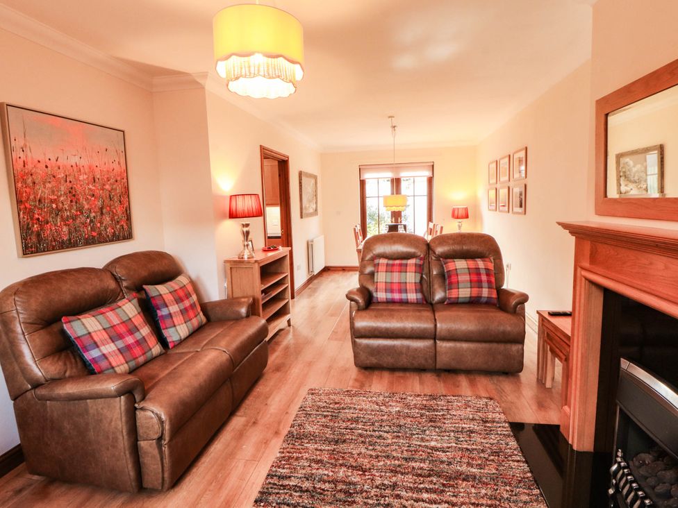 A living room with a sofa and coffee table at Derwent Cottage in Cockermouth