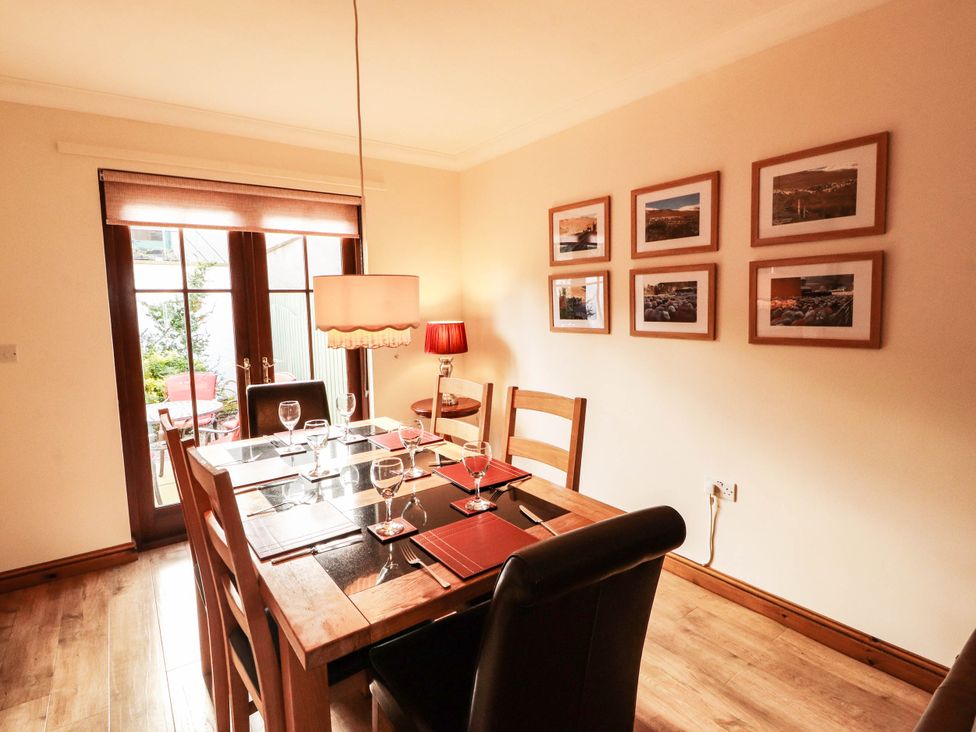 A dining room with a table set for dinner at Derwent Cottage in Cockermouth