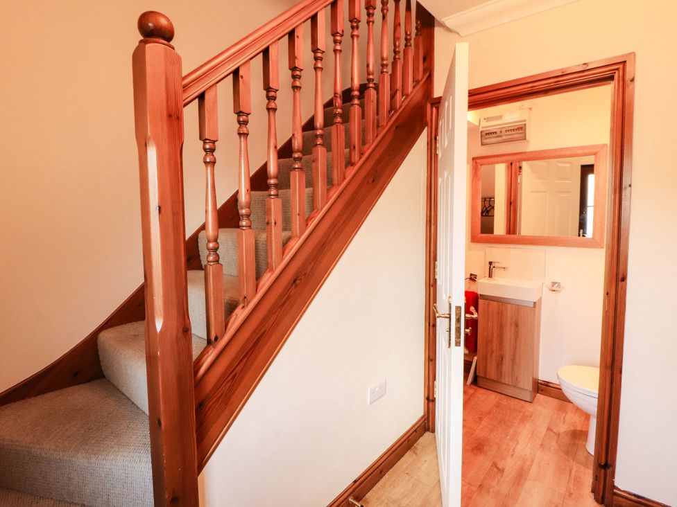A hallway with a staircase and a bathroom at Derwent Cottage in Cockermouth