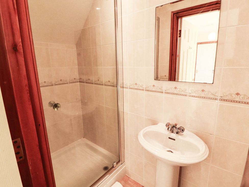 A bathroom with a shower and sink at Derwent Cottage in Cockermouth