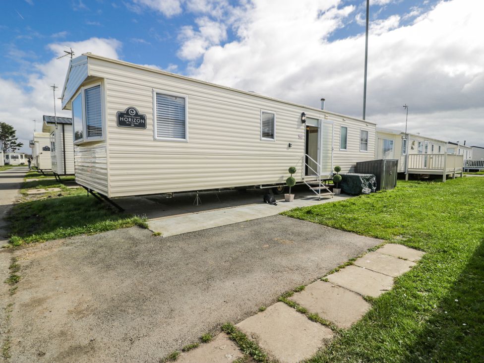 A caravan with a sign at 51 Silverbirch Way in Rhyl