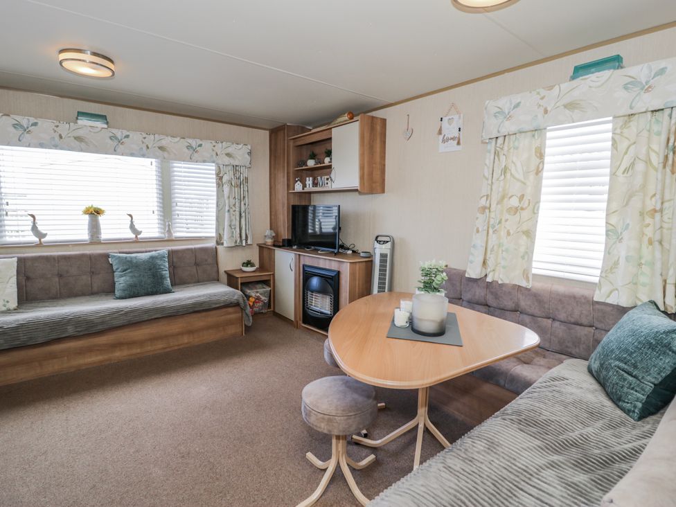 A living room with a sofa and coffee table at 51 Silverbirch Way in Rhyl