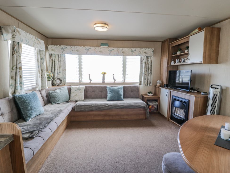 A living room with a sofa and television at 51 Silverbirch Way in Rhyl