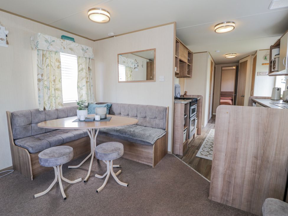 A dining area with a sofa and table at 51 Silverbirch Way, Rhyl