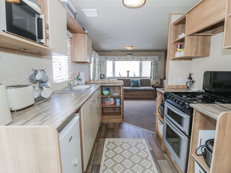 A kitchen with appliances and cabinets at 51 Silverbirch Way in Rhyl
