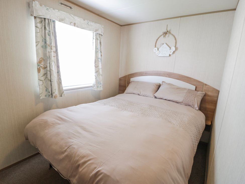 A bedroom with a bed and window at 51 Silverbirch Way in Rhyl