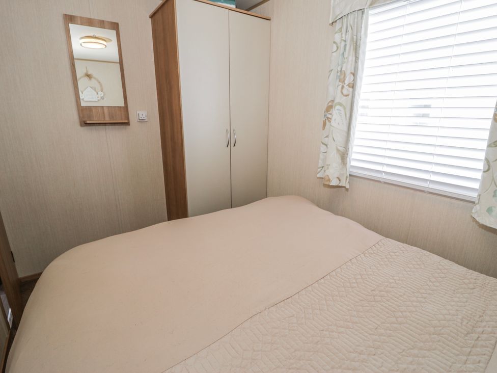 A bedroom with a bed and cupboard at 51 Silverbirch Way Rhyl