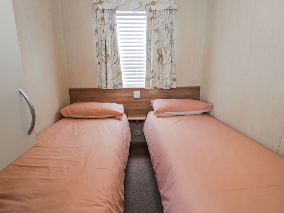 A bedroom with two single beds at 51 Silverbirch Way in Rhyl