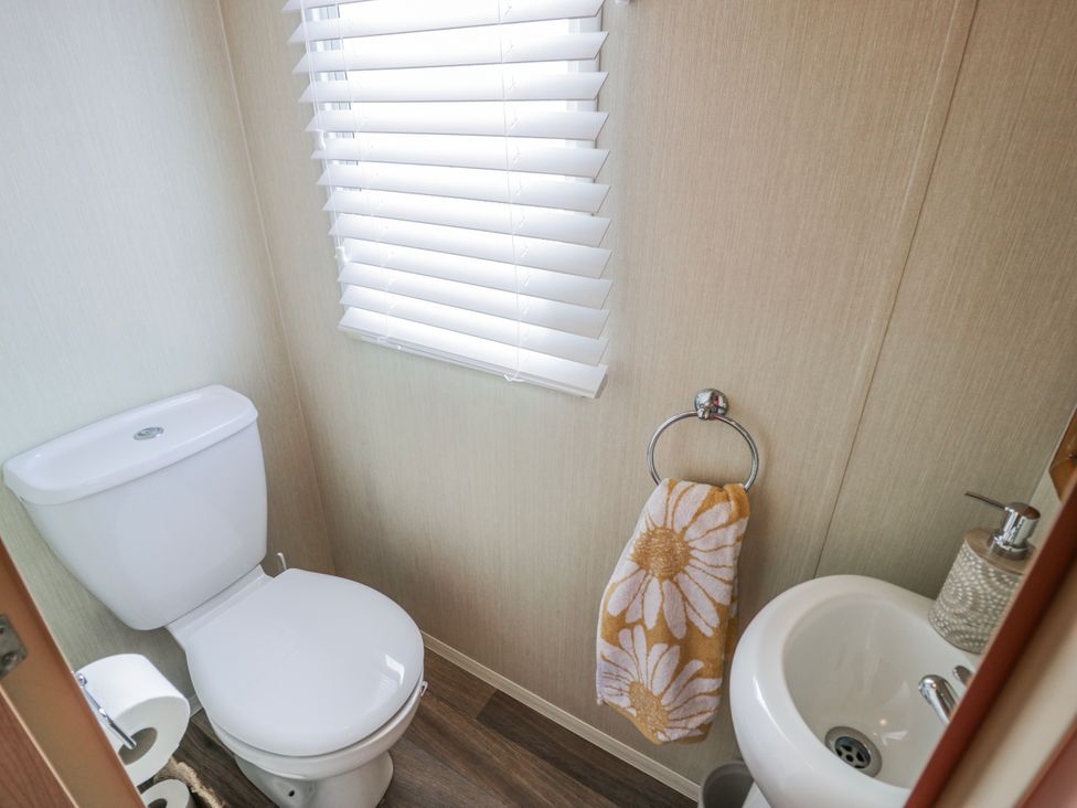 A bathroom with a toilet and sink at 51 Silverbirch Way, Rhyl