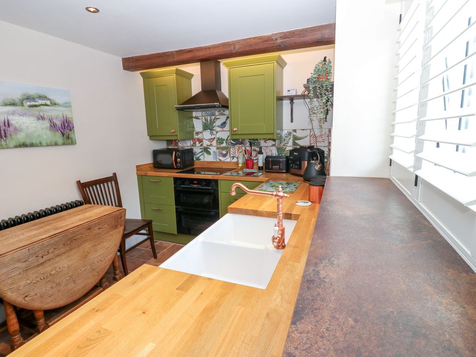A kitchen with a sink and cabinets at 14 The Porch in Barton