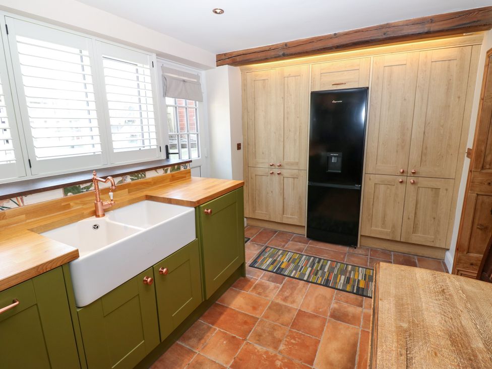 A kitchen with a sink and refrigerator at 14 The Porch in Barton