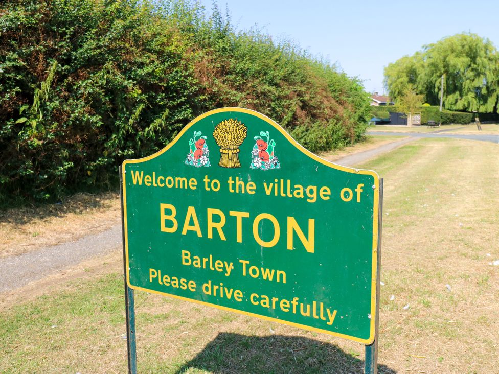 A welcome sign for the village of Barton, Barley Town
